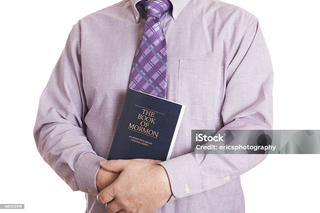 Mormon Man in shirt and tie holding The Book of Mormon. White background. Mormonism Stock Photo