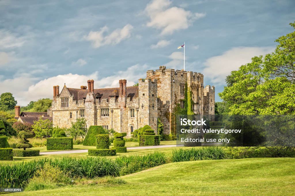 Hever castle and gardens in Kent, England Hever, England - June 18, 2015: A view of Hever Castle in Kent showing part of gardens. Hever Castle was the home of Anne Boleyn, the second wife of King Henry VIII.  British Royalty Stock Photo