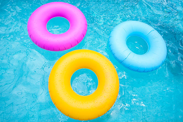 istock Group of colorful inflatable tubes floating in a swimming pool 481319364