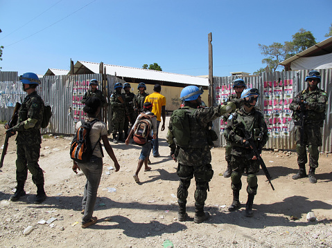 Port-au-Prince, Haiti - March 20, 2011:  Brazilian United Nations peacekeeping troops provide security outside a polling place during the presidential run-off election.  The run-off pitted Mirlande Manigat of the RDNP party against Michel Martelly of the Repons Peyizan party, the eventual winner.