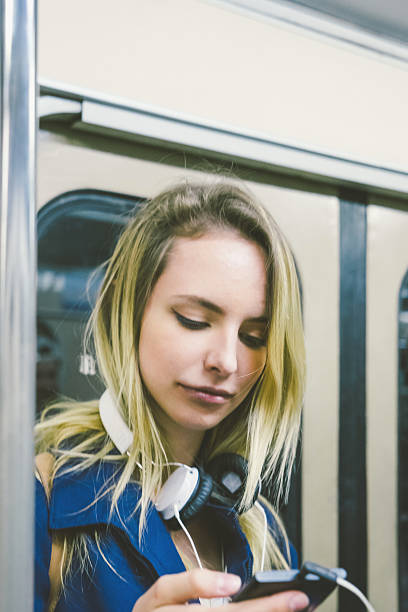 istock Beautiful Woman On Subway Train Using Smartphone 481320130