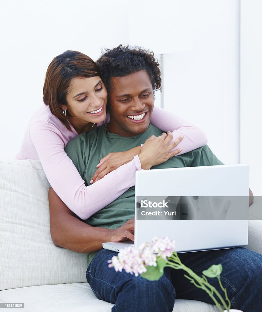Young couple working on laptop in house Adult Stock Photo