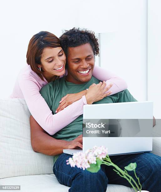 Young Couple Working On Laptop In House Stock Photo - Download Image Now - Adult, Cheerful, Color Image