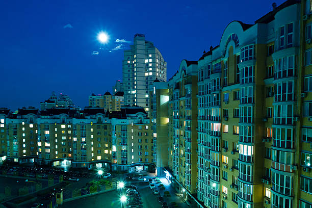istock Moon in the night sky over city. 481321634