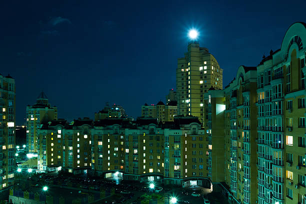 istock Moon in the night sky over city. 481321644