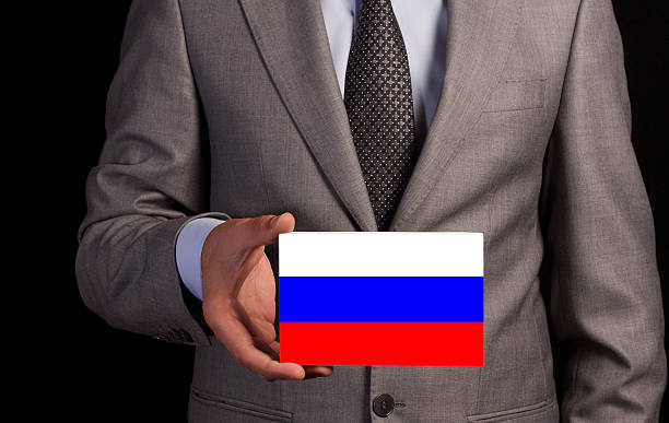 Businessman Holding a Card with RUSSIA Flag
