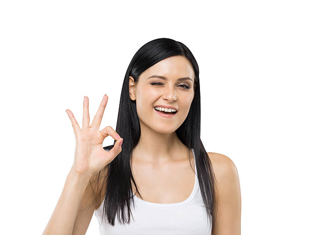 istock Brunette woman shows ok sign. Isolated. 481326286