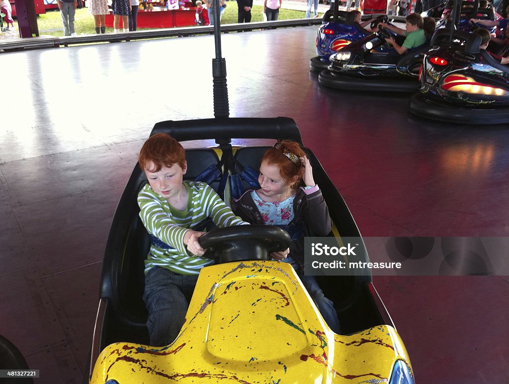 Children on Funfair Dodgems Children at Fairground enjoying the Bumper cars Activity Stock Photo