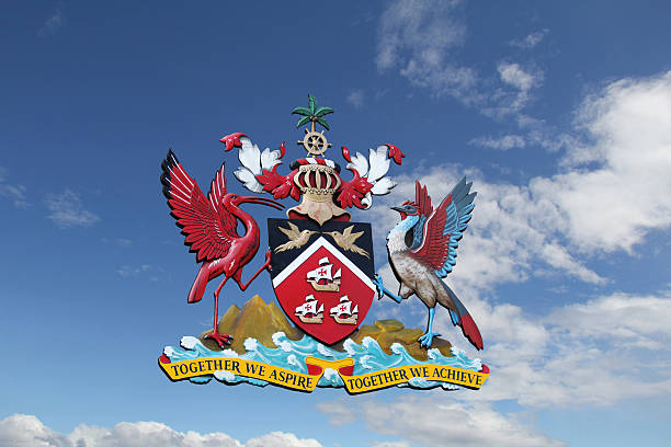 The crest of Trinidad and Tobago against a sky blue background