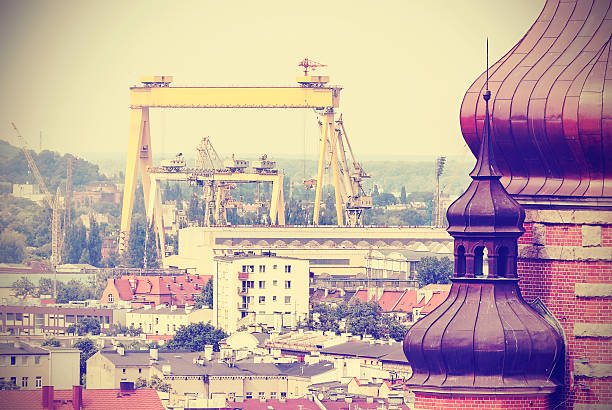 Retro postcard from Szczecin, historic building and industrial background, Poland.