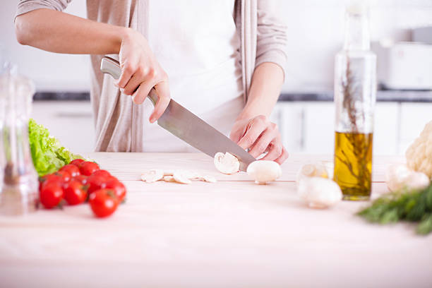 istock Woman cutting mushrooms 481329418
