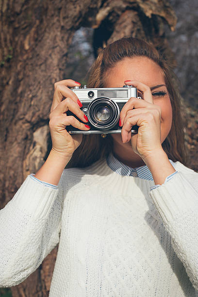 istock Retro beautiful girl photographing 481329754