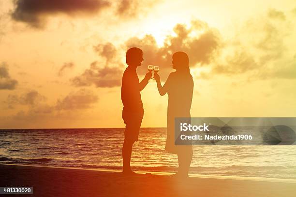 Silhouette Of Couple Drinking Wine At Sunset Stock Photo - Download Image Now - 2015, Adult, Adults Only