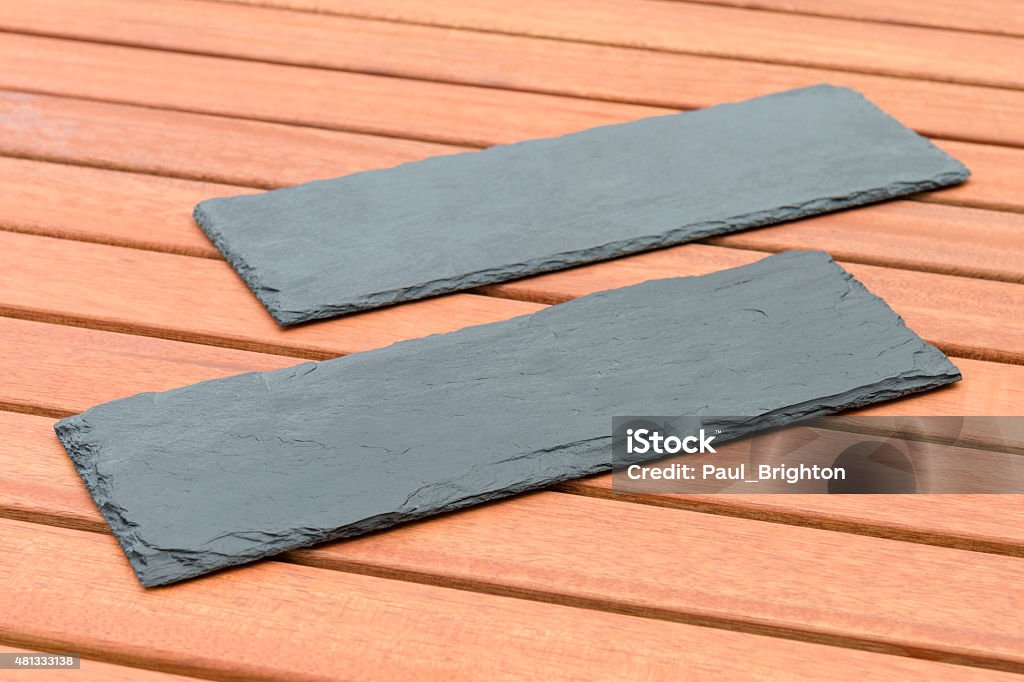 Empty Slates Empty Slate - Black serving platters on a wooden table outdoors. 2015 Stock Photo