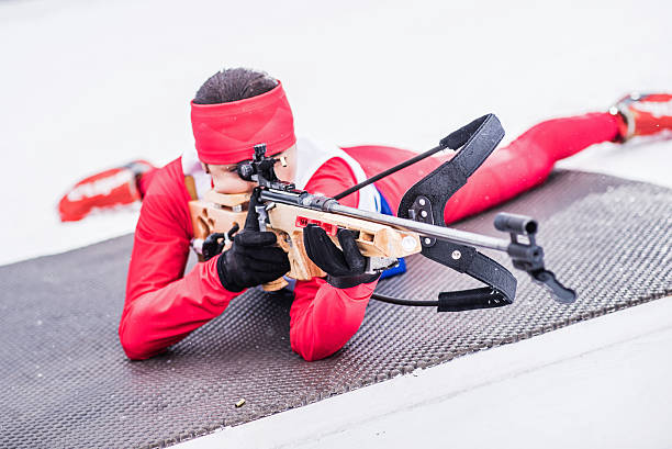 istock Athletic woman with biathlon rifle 481333332