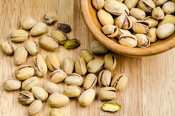 istock roasted and salted pistachios on wooden background 481333864
