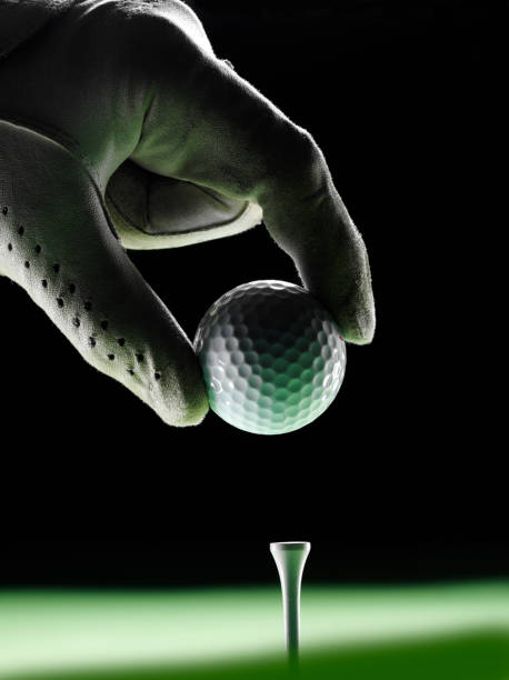 The golf sport equipment  white glove ,golf ball, golf club and  yellow tee golf with green grass background.