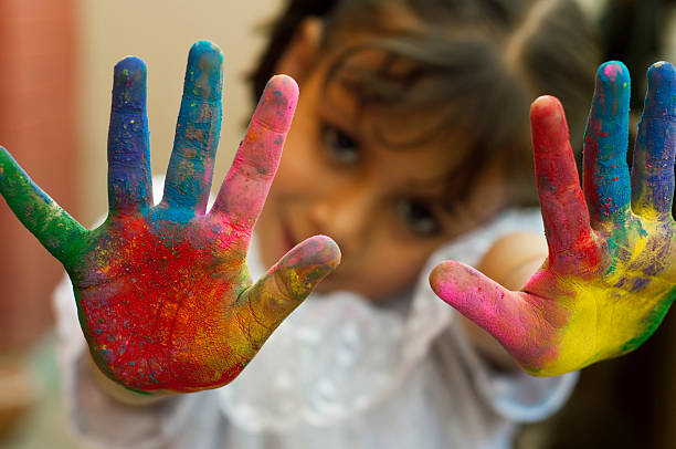istock Girl showing colorful painted hands 481336189