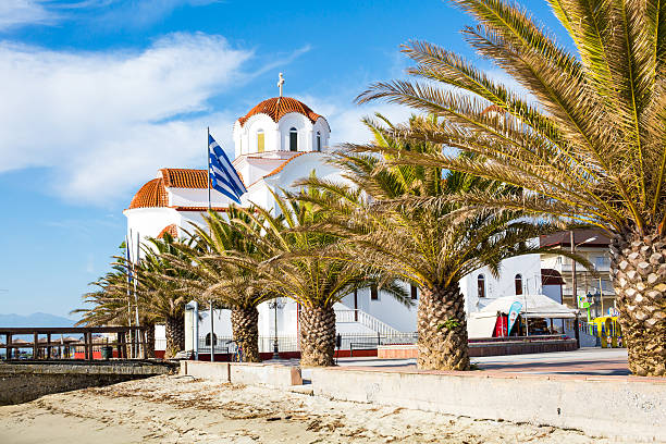 Greek orthodox Church in Paralia Katerini beach, Greece Greek orthodox Church in Paralia Katerini, wooden pier, palm trees and sandy beach, Greece paralia stock pictures, royalty-free photos & images