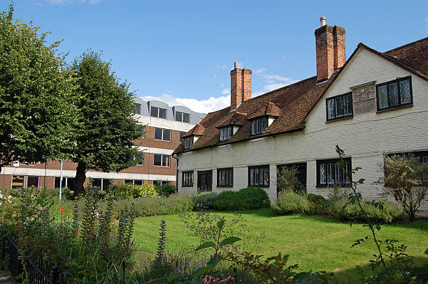 Historic seventeenth century almshouses with beautiful cottage gardens in the centre of Basingstoke, Hampshire.  Viewed on a sunny afternoon in August.