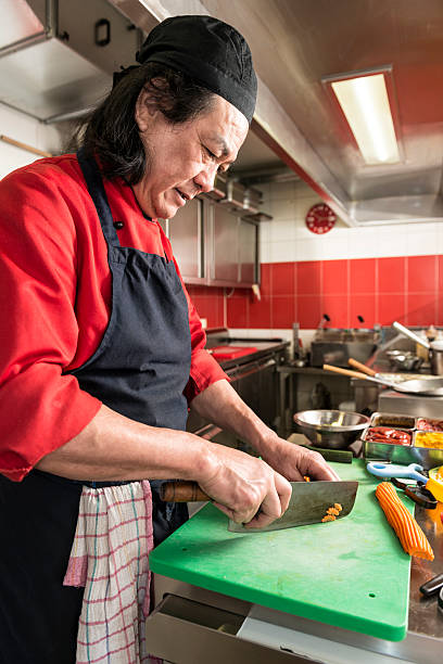 istock chinese cook cutting vegetables in asian restaurant 481338497