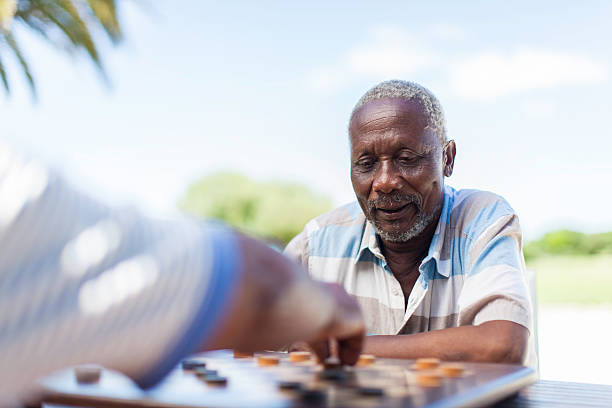 istock African seniors playing chess together 481339283