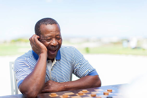 istock African senior getting excited about the game 481339375