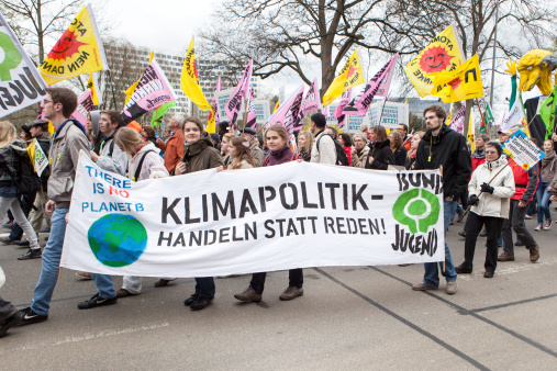 Wiesbaden, Germany - March 22, 2014: Participants of Energiewende retten - demonstration in the city center of Wiesbaden., holding up a large banner. Protesters in several cities demonstrate for the rapid expansion of renewable energy. The demonstrations were organized by anti-nuclear organization .ausgestrahlt, BUND (Bund fuer Umwelt und Naturschutz Deutschland), campaign network campact and several regional environmental protection organisations.