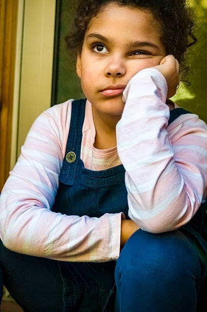 istock PEOPLE: Unhappy Child (7-8) With Hand On Chin Sitting Outside 481340291