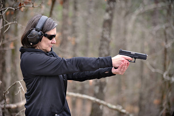 istock Woman Shooting a Pistol 481340437