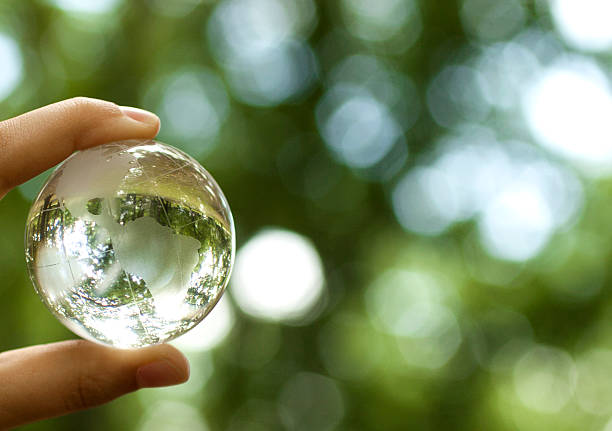 World environment concept World environmental concept. Crystal globe in human hand on beautiful green bokeh. Visible are the continents the Americas power energy development abstract stock pictures, royalty-free photos & images