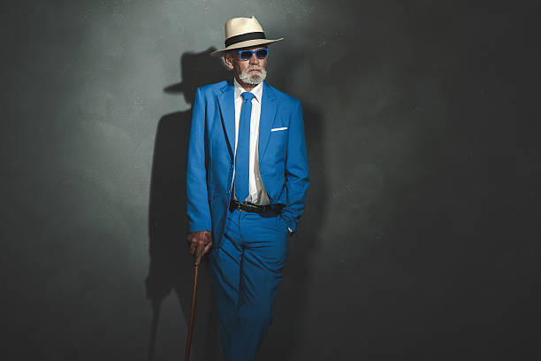 istock Elegant Senior Man with Cane Leaning Against Wall 481340958