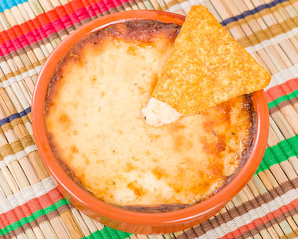 Baked Cheese Baked Cheese - Melted cheese dip served with tortilla chips. cheese dip stock pictures, royalty-free photos & images