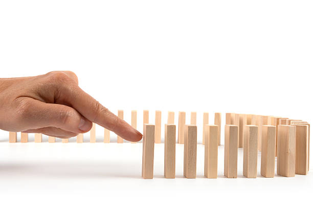 istock Hand kicking Domino pieces standing in a row for cascade 481345162