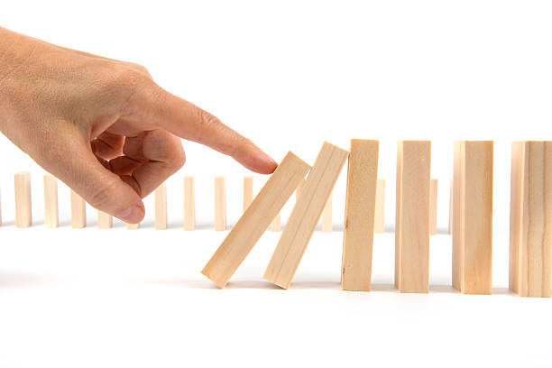 istock Hand kicking Domino pieces standing in a row for cascade 481345174