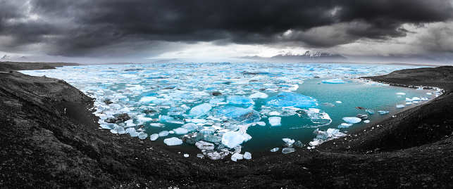 Beautiful 180 degree panoramic view of the floating blue ice in the Jokulsarlon lake in Iceland in winter