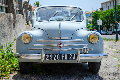 Ajaccio, France - July 6, 2015: Light blue Renault 4CV old-timer economy car stands parked on a roadside in French town