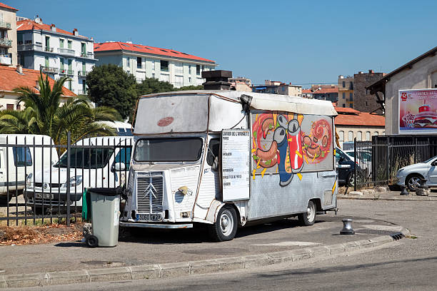 Old white Citroen H Van, catering trailer Ajaccio, France - June 30, 2015: Old white Citroen H Van, light truck converted to catering trailer with colorful advertising graffiti  and a menu citroen hy stock pictures, royalty-free photos & images