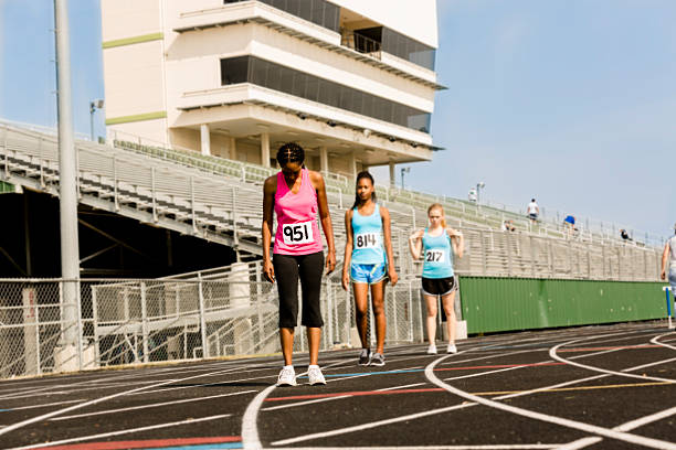 istock Sports: Women's track competition.  Three runners prepare for race. 481346749