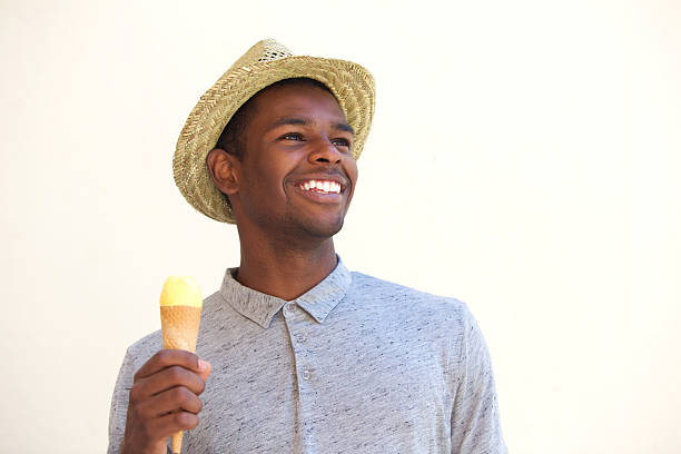 Close up portrait of a smiling young african american man holding ice cream cone