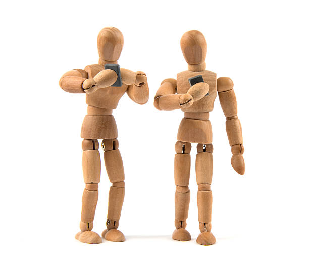 istock walking wooden mannequin looking only to smartphone 481349798