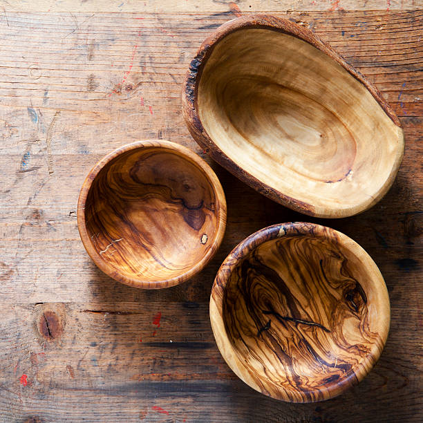 istock Three wooden bowls from olive tree on a wooden background 481350124