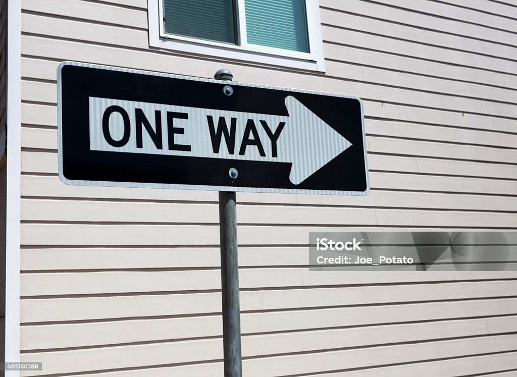 One Way Sign One Way sign with wall in background. Horizontal. 2015 Stock Photo