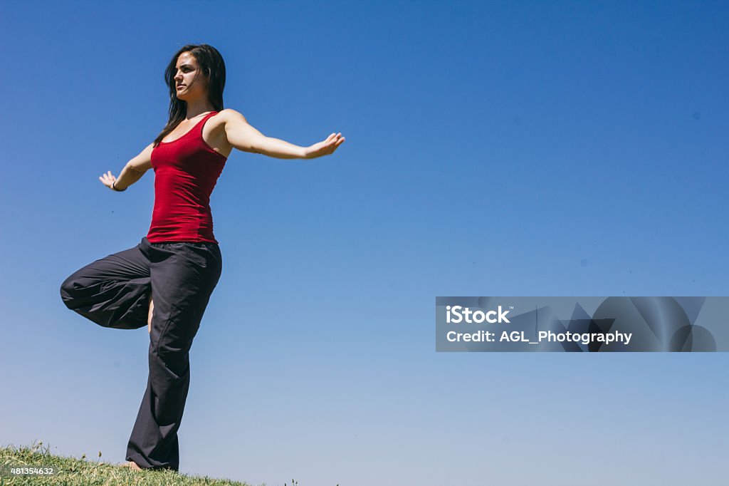 Woman doing yoga outdoors Photography of woman doing yoga outdoors 2015 Stock Photo