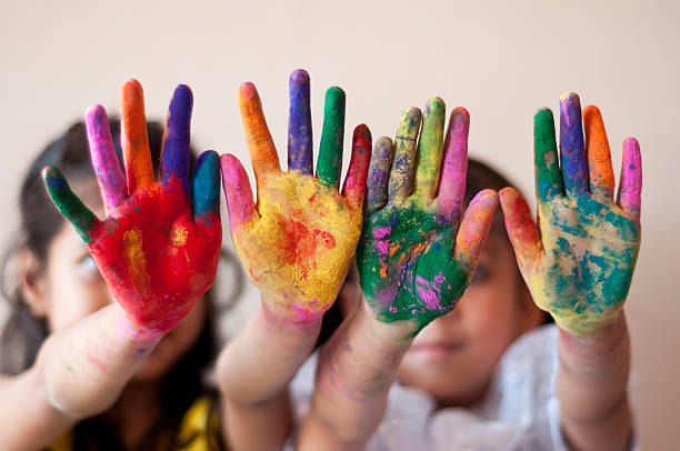 istock Two girls showing colorful painted hands 481356311