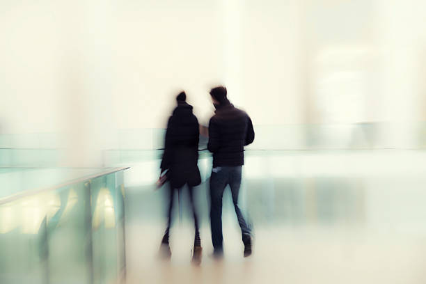 istock Abstract Image Of Two People Walking In Modern Interior 481358160