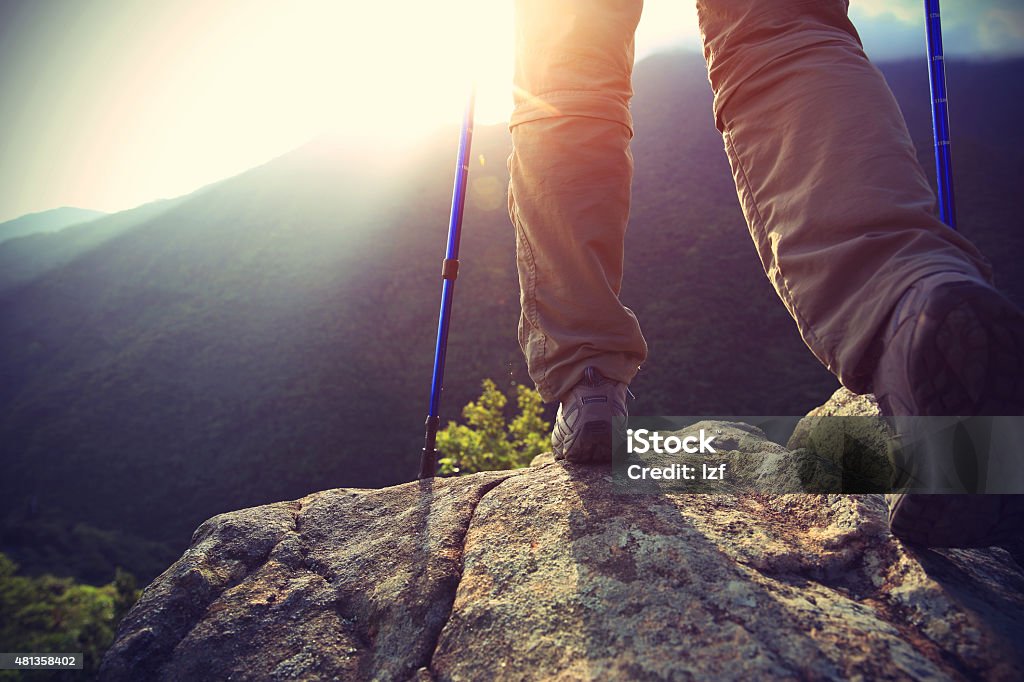 woman hiker legs stand on mountain peak rock 2015 Stock Photo