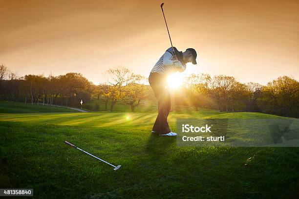 Backlit Golf Course With Golfer Chipping Onto Green Stock Photo - Download Image Now