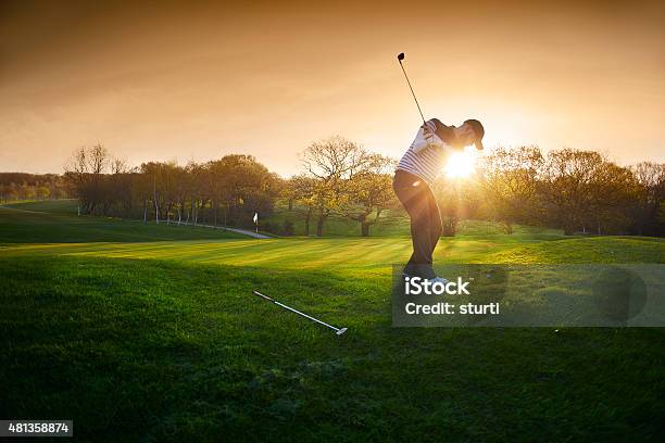 Backlit Golf Course With Golfer Chipping Onto Green Stock Photo - Download Image Now