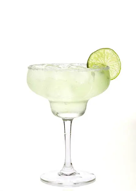 Glass of margarita cocktail on a white background.